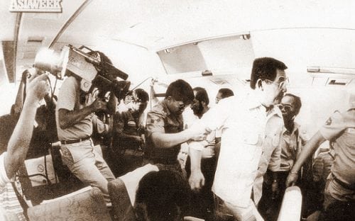 Ninoy being escorted by military people from China Airlines