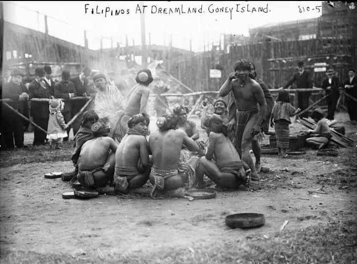 Igorots huddle for warmth and comfort as Coney Island’s Dreamland visitors check them out